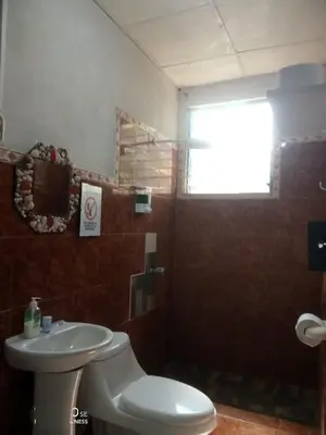 a bathroom with a toilet and a sink at Las Brisas Casa frente al mar Costa del Sol in El Zapote