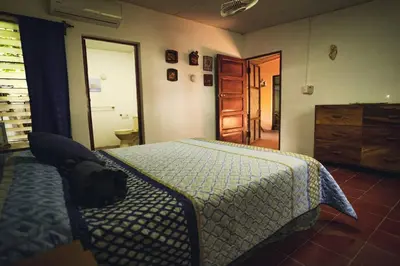 a bedroom with a bed and a dresser at Sihua Escape in Teotepeque