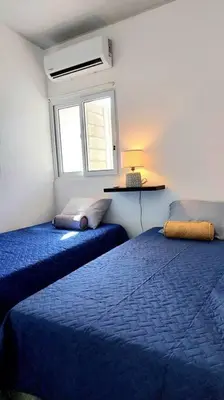 a bedroom with two beds and a window at Confort Express en San Miguel in San Miguel