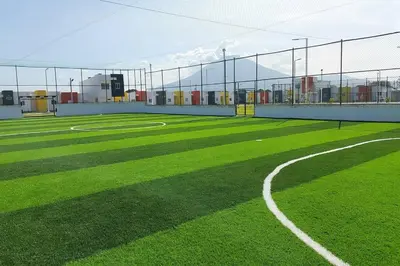 a baseball field with green grass and a fence at Confort Express en San Miguel in San Miguel