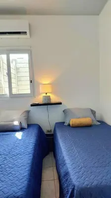 a bedroom with two beds and a window at Confort Express en San Miguel in San Miguel