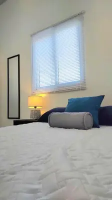 a bedroom with a large white bed with a window at Confort Express en San Miguel in San Miguel