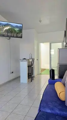 a living room with a couch and a tv on the wall at Confort Express en San Miguel in San Miguel