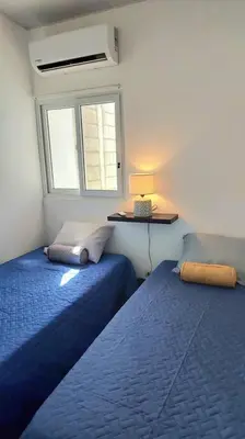 a bedroom with two beds and a window at Confort Express en San Miguel in San Miguel