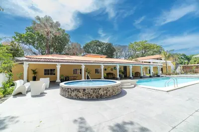 an outdoor patio with a pool and a house at Chalatenango Country Club & Resort in Chalatenango