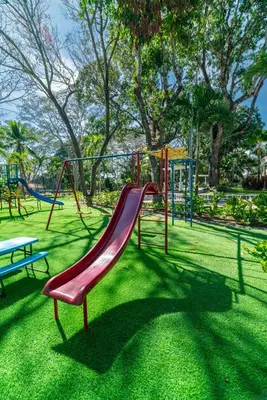 a playground with a red slide in a park at Chalatenango Country Club & Resort in Chalatenango
