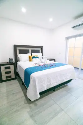 a bedroom with a bed with a swan on it at Chalatenango Country Club & Resort in Chalatenango