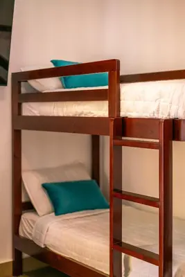 two bunk beds in a room with blue pillows at Chalatenango Country Club & Resort in Chalatenango