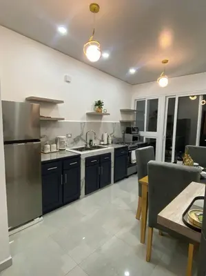 a kitchen with stainless steel appliances and a table at Golden Glow Getaway in San Miguel