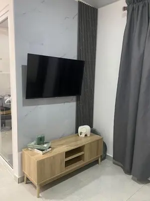 a flat screen tv on a wall in a living room at Golden Glow Getaway in San Miguel