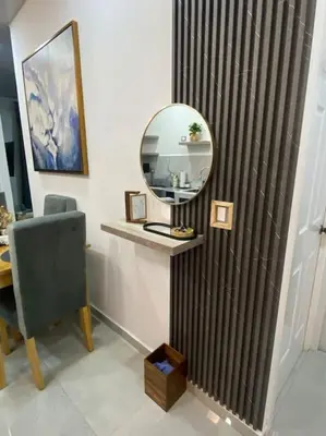 a room with a mirror and a table with a chair at Golden Glow Getaway in San Miguel