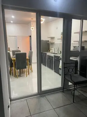 a view of a kitchen with a table and chairs at Golden Glow Getaway in San Miguel