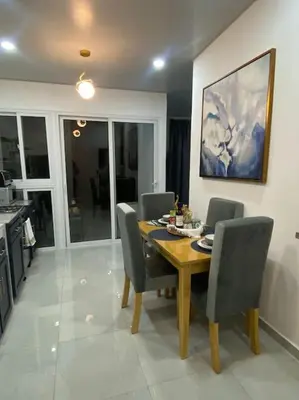 a dining room with a wooden table and chairs at Golden Glow Getaway in San Miguel