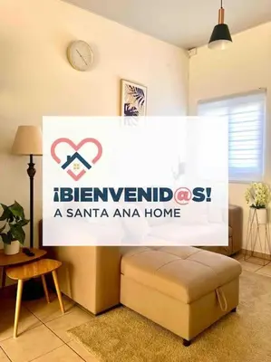 a sign for a santa ana home in a room at Acogedora Residencia Santaneca in Santa Ana