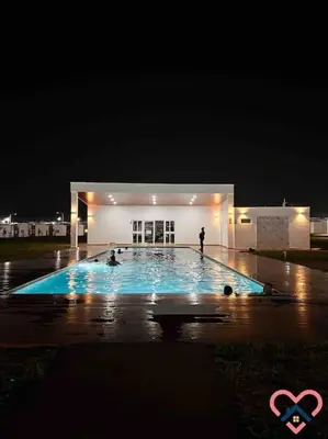 a person standing in front of a building at night at Acogedora Residencia Santaneca in Santa Ana