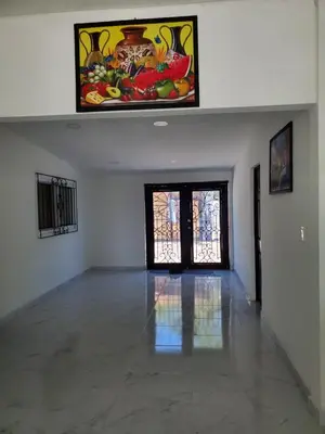 an empty room with a large painting on the wall at Beach house playa san diego in La Libertad