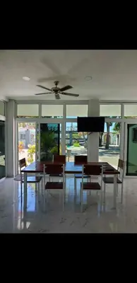 a dining room with a table and chairs and a piano at Beach house playa san diego in La Libertad