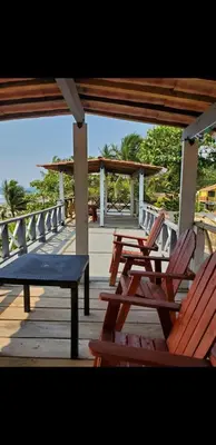 a group of chairs and a bench on a deck at Beach house playa san diego in La Libertad