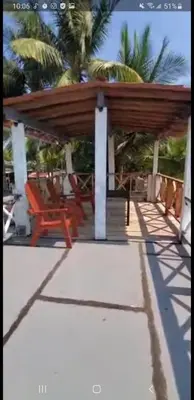 a pavilion with a table and chairs on a porch at Beach house in la libertad in La Libertad
