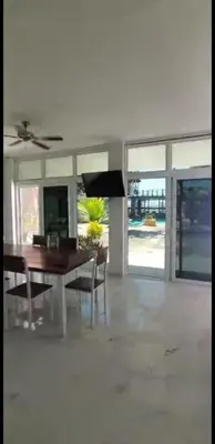 a living room with a dining room table and chairs at Beach house in la libertad in La Libertad