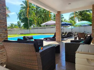a patio with wicker furniture and a swimming pool at Rancho Plèyades in Metalío