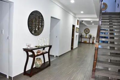 a hallway with a table and stairs in a house at Rancho Plèyades in Metalío