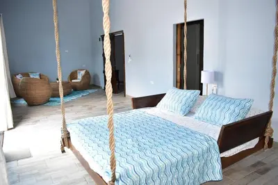 a bedroom with a bed and a swing at Rancho Plèyades in Metalío