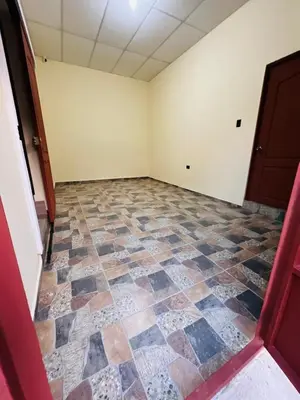 an empty room with a checkered floor at Bambú Family House, AC, WiFi, near Metrocentro Mall in Santa Ana