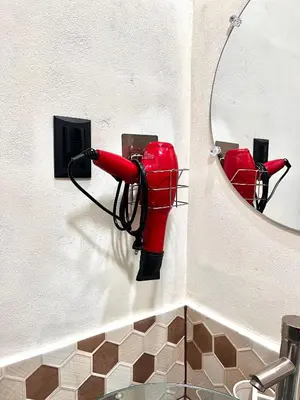 a red fire hydrant on a wall next to a mirror at Bambú Family House, AC, WiFi, near Metrocentro Mall in Santa Ana
