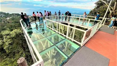 people standing on the glass floor of a glass revolving building at Hotel Five Stars sv in Berlín