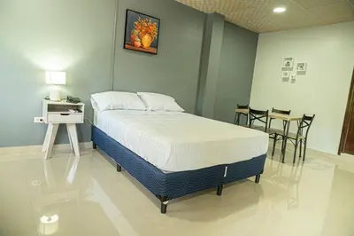 a bedroom with a bed and a table and chairs at Hotel Five Stars sv in Berlín