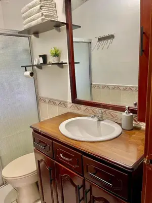 a bathroom with a sink and a mirror at Casa Familiar in San Miguel