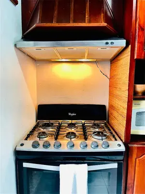 a stove top oven sitting inside of a kitchen at Casa Familiar in San Miguel