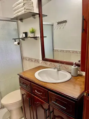 a bathroom with a sink and a mirror at Casa Familiar in San Miguel