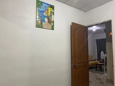 a picture hanging on a wall next to a door at Casa las Flores in San Miguel