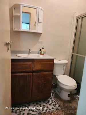 a bathroom with a sink and a toilet at Casa las Flores in San Miguel