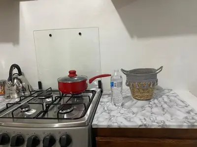 a kitchen stove with a pot on top of it at Casa las Flores in San Miguel