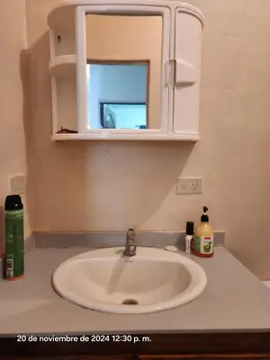 a bathroom counter with a sink and a mirror at Casa las Flores in San Miguel