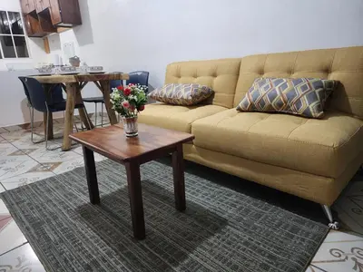 a living room with a couch and a table with flowers at Casa las Flores in San Miguel
