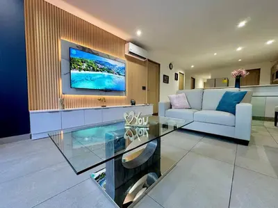 a living room with a couch and a glass table at Cool Spot By Rooftop Masferrer in San Salvador