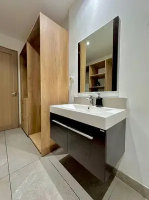 a bathroom with a white sink and a mirror at Cool Spot By Rooftop Masferrer in San Salvador