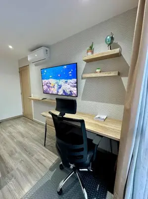 an office with a desk with a computer and a chair at Cool Spot By Rooftop Masferrer in San Salvador