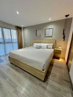 a bedroom with a large bed and a large window at Cool Spot By Rooftop Masferrer in San Salvador