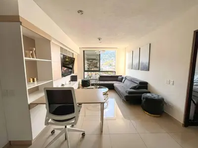 a living room with a table and a couch at Upper Scale and Cozy Apart in the Heart of Escalon in San Salvador