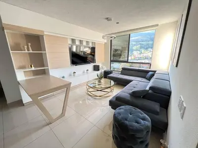 a living room with a couch and a table at Upper Scale and Cozy Apart in the Heart of Escalon in San Salvador