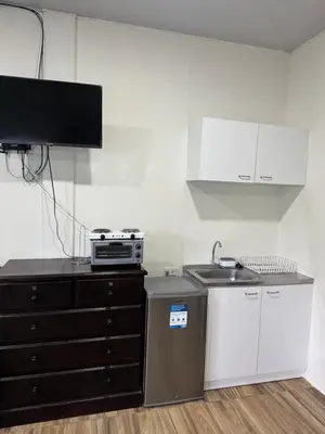 a kitchen with a sink and a stove and a counter at Emmitas room in Juayúa