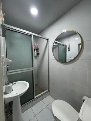 a bathroom with a shower and a sink and a mirror at Emmitas room in Juayúa