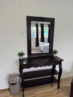 a bathroom vanity with a mirror on top of it at Emmitas room in Juayúa