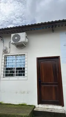 a white house with a door and a window at Emmitas room in La Unión