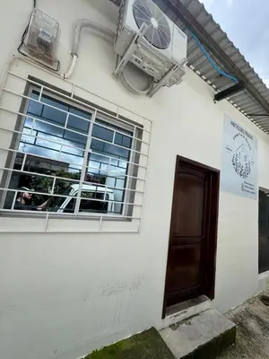 a white house with a window and a door at Emmitas room in La Unión